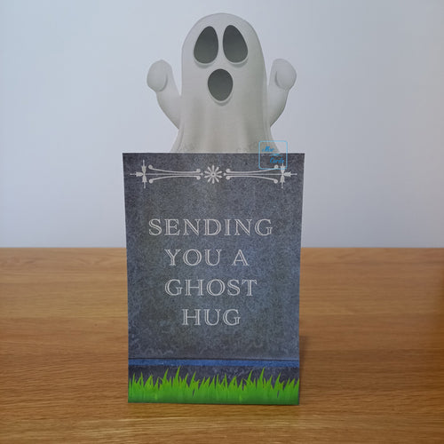 ghost peeking over the top of a gravestone.