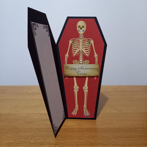 Coffin card with a skeleton holding a placard